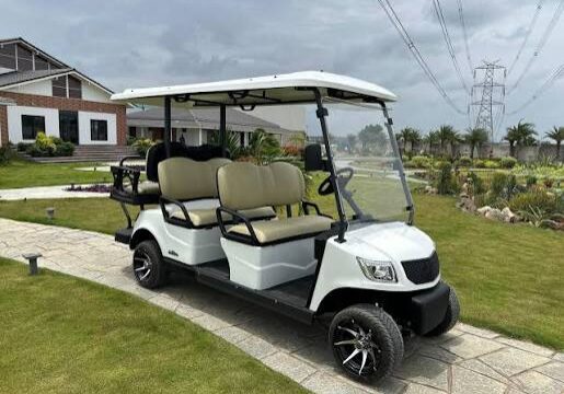 White golf cart rental parked on a scenic beach road